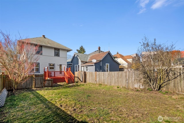 view of yard with a fenced backyard and a wooden deck