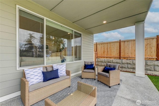 view of patio featuring an outdoor hangout area and fence