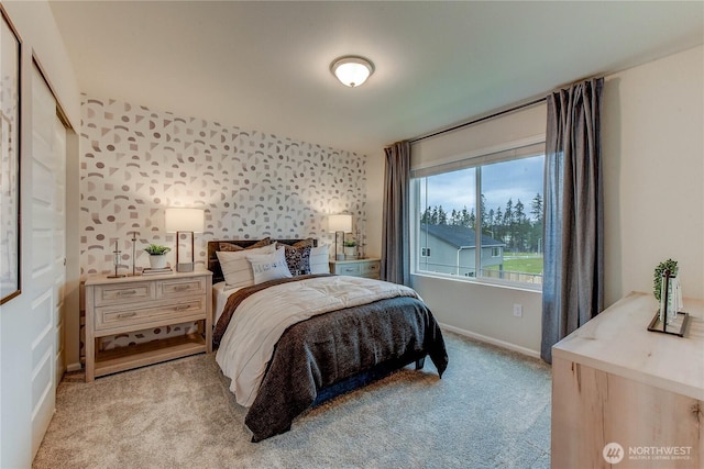 bedroom featuring baseboards and light colored carpet