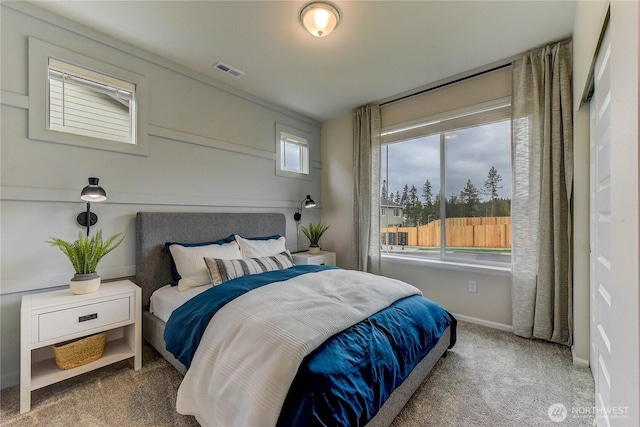 carpeted bedroom featuring visible vents and baseboards