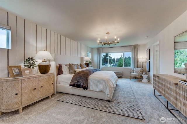 carpeted bedroom with multiple windows and a chandelier