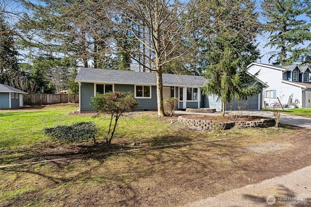 ranch-style house with a front yard, fence, driveway, a garage, and crawl space