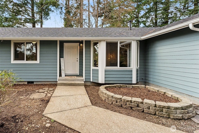 property entrance with a shingled roof