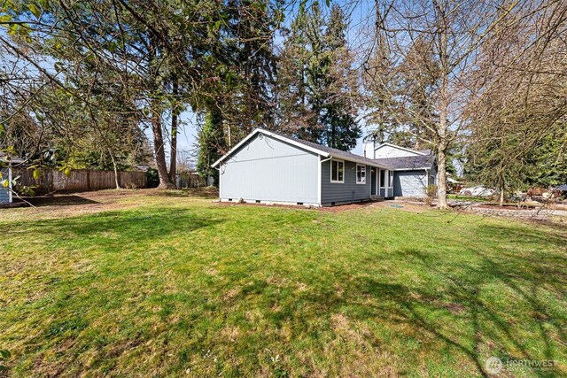 view of yard with a garage and fence