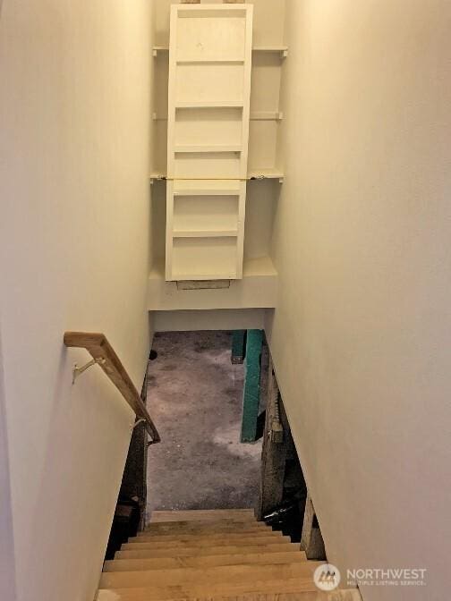 staircase featuring wood finished floors