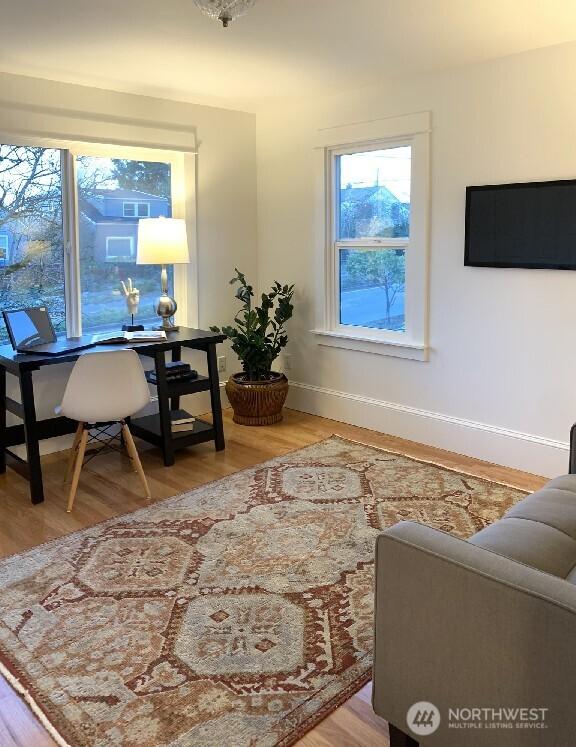 home office featuring wood finished floors and baseboards