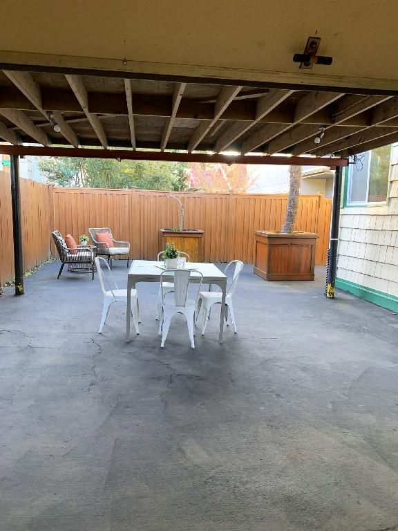 view of patio / terrace featuring outdoor dining area and fence