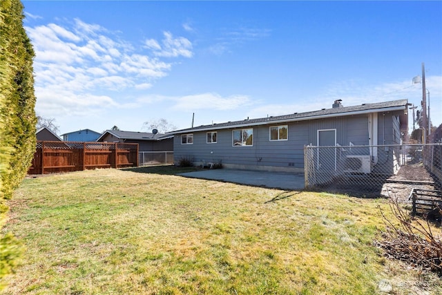 rear view of house with a patio, a lawn, and a fenced backyard