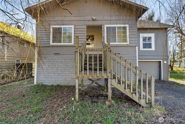 exterior space with stairs, driveway, and an attached garage