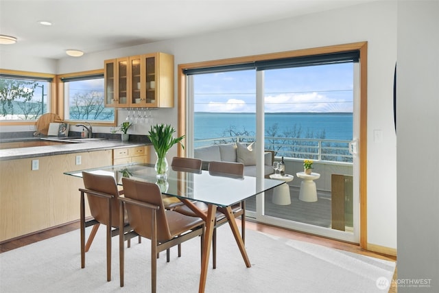 dining space with light wood-style flooring and baseboards