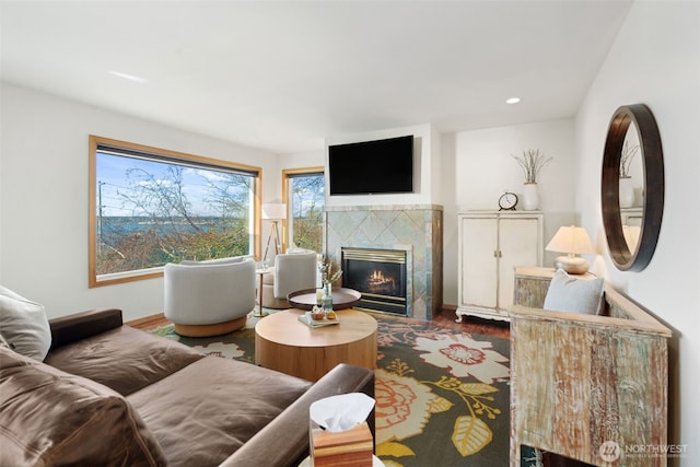 living room with recessed lighting, wood finished floors, and a tile fireplace