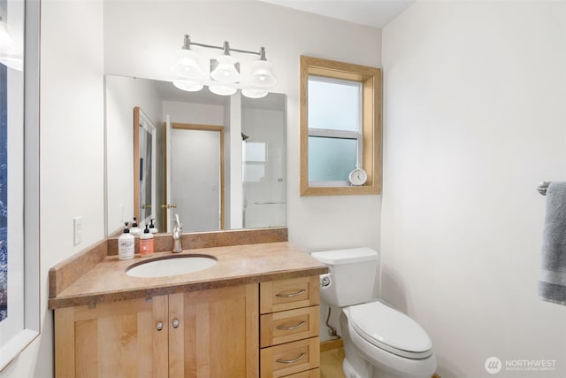 bathroom featuring toilet and vanity