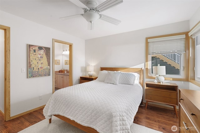 bedroom with baseboards, connected bathroom, a ceiling fan, and wood finished floors