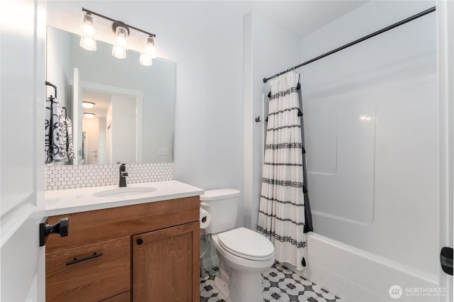 full bath featuring vanity, shower / tub combo, backsplash, and toilet