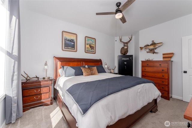 bedroom with baseboards, a ceiling fan, and light colored carpet