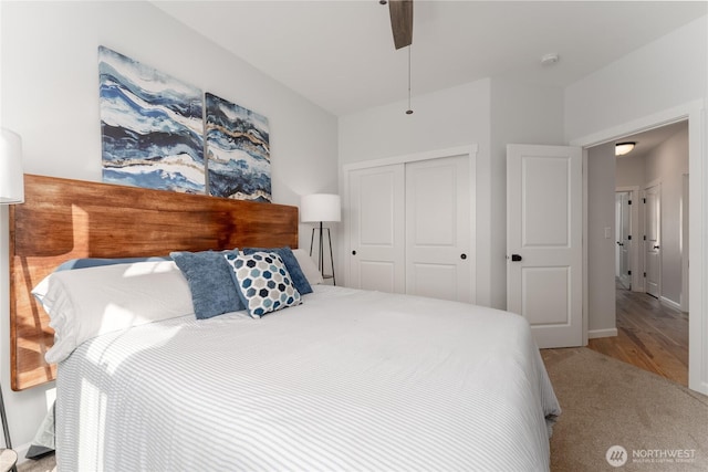 bedroom with carpet, ceiling fan, baseboards, and a closet