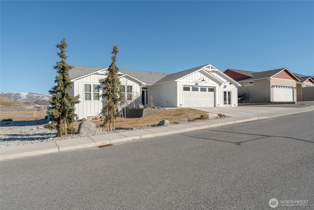 view of front of property featuring concrete driveway, board and batten siding, and an attached garage