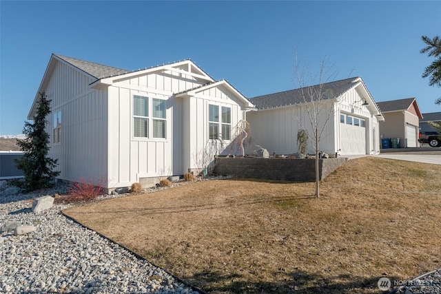 view of front of home with driveway, a shingled roof, an attached garage, board and batten siding, and a front yard