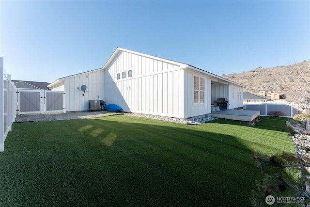 view of outbuilding featuring a gate, a fenced backyard, and central air condition unit