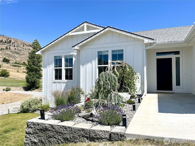 422 Sunny Brooke Ln, Chelan, WA 98816 - entrance to property with board and batten siding, a shingled roof, and a mountain view