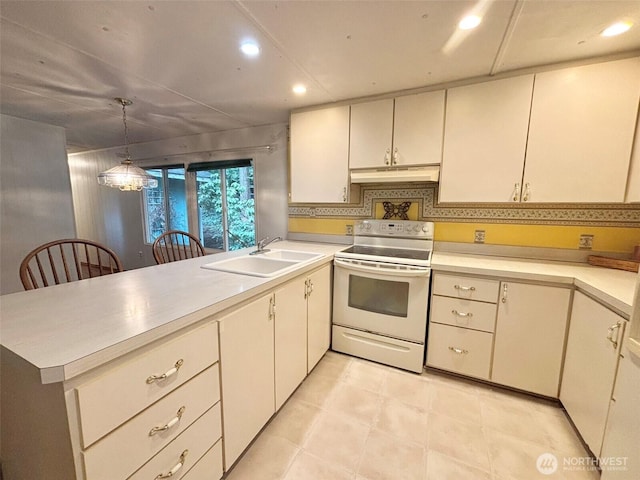 kitchen featuring light countertops, electric range, a sink, a peninsula, and under cabinet range hood