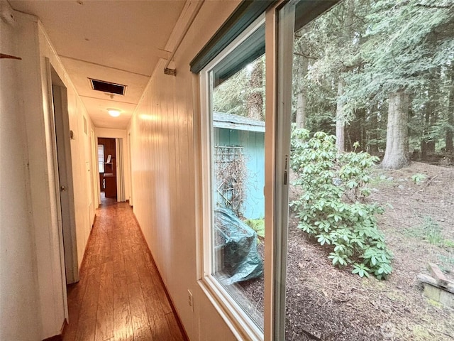 corridor featuring wood-type flooring and visible vents