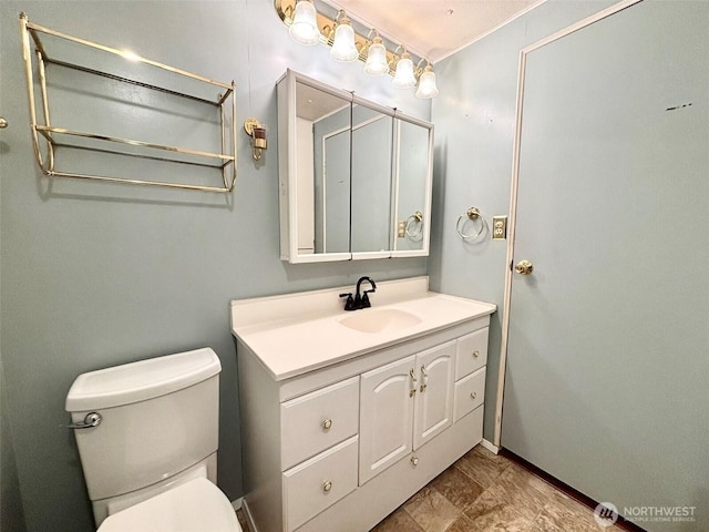 bathroom with toilet and vanity