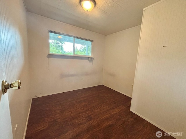 spare room featuring dark wood-style flooring