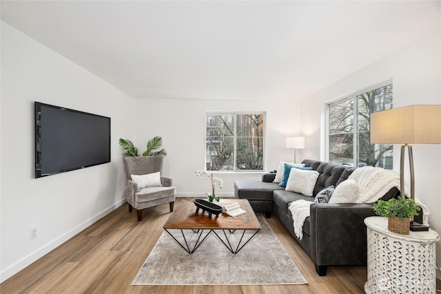 living area with light wood-style floors and baseboards