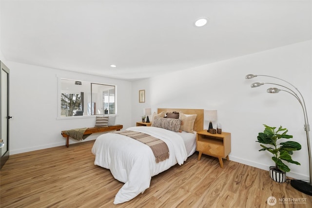 bedroom with light wood-type flooring, baseboards, and recessed lighting