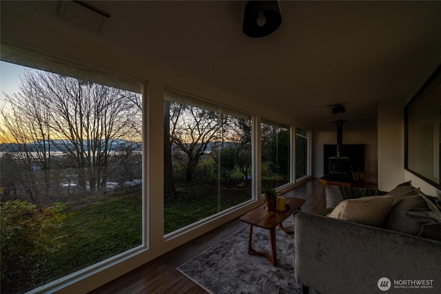 sunroom / solarium featuring a wood stove