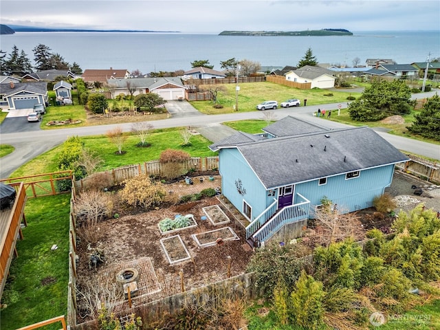 drone / aerial view with a residential view and a water view