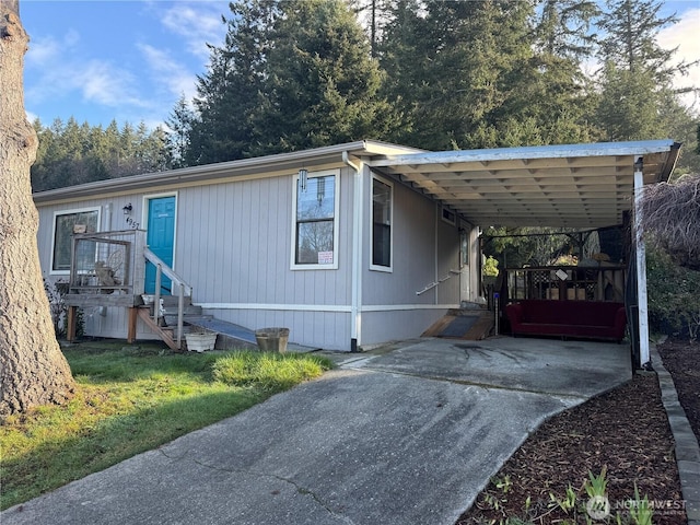 view of front of property with an attached carport and driveway