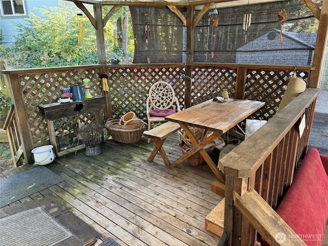 wooden terrace featuring outdoor dining area