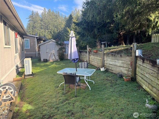 view of yard featuring an outbuilding, a fenced backyard, a storage shed, and central air condition unit