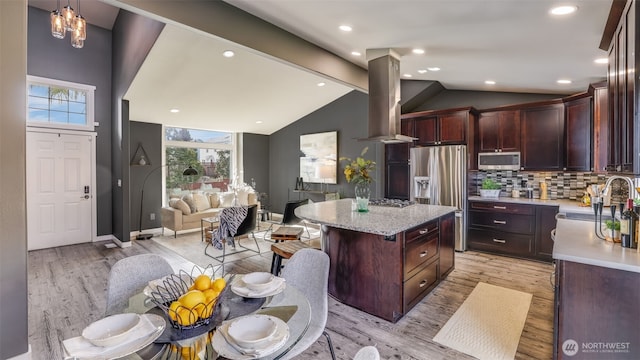 kitchen with stainless steel appliances, a sink, light wood-style flooring, and island range hood