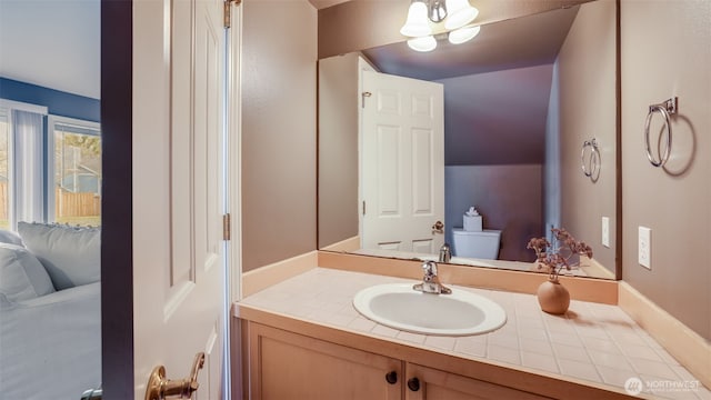 half bathroom featuring vanity and toilet