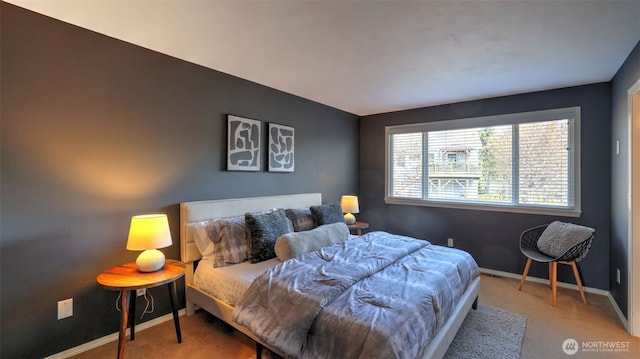 carpeted bedroom featuring baseboards