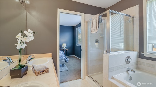 full bath featuring a stall shower, a garden tub, and a sink