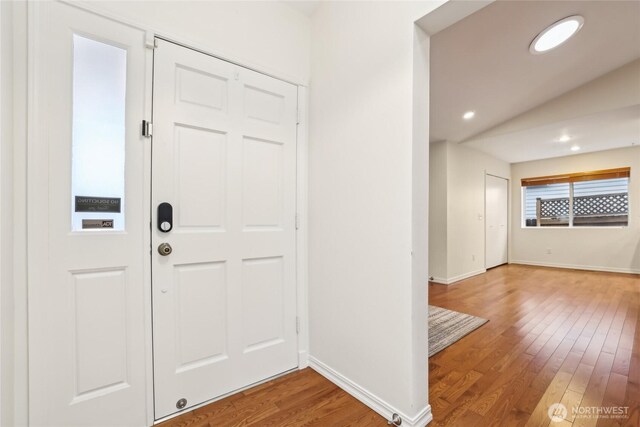 foyer with recessed lighting, wood finished floors, and baseboards