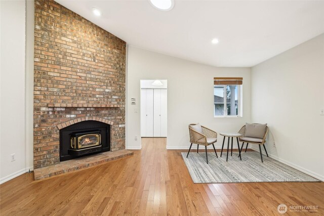 sitting room with vaulted ceiling, recessed lighting, baseboards, and wood-type flooring