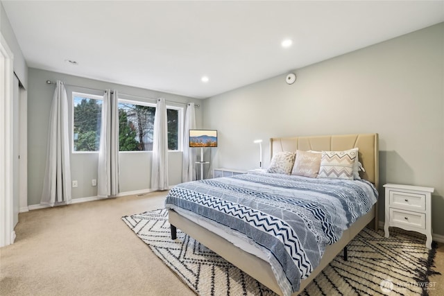 carpeted bedroom featuring recessed lighting and baseboards