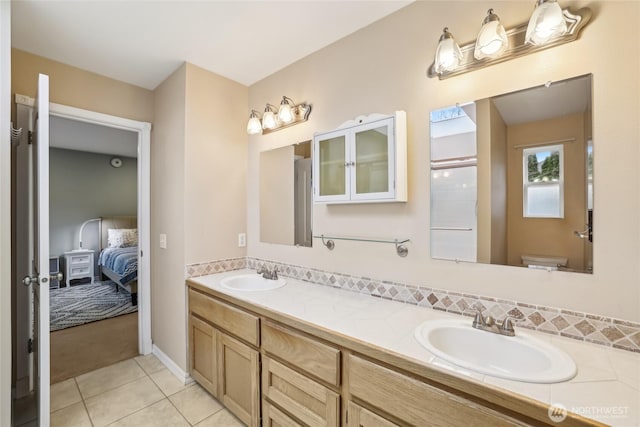 full bathroom with tile patterned floors, connected bathroom, double vanity, and a sink