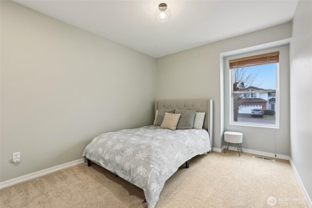 bedroom featuring visible vents, baseboards, and carpet flooring