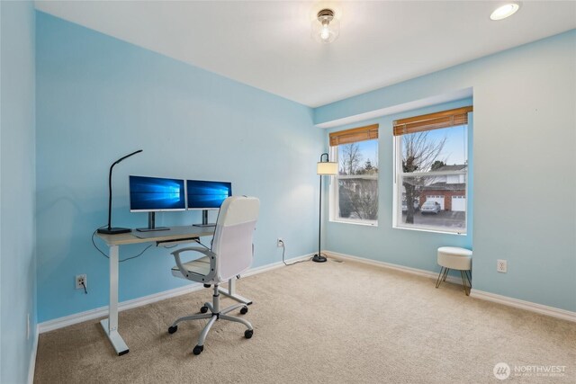 carpeted home office with baseboards