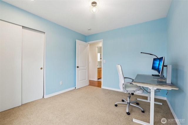 carpeted home office with baseboards