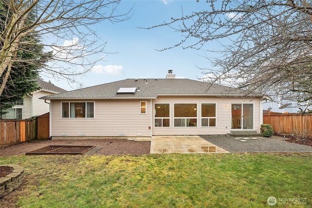 back of property featuring a patio, roof with shingles, a yard, a fenced backyard, and a chimney