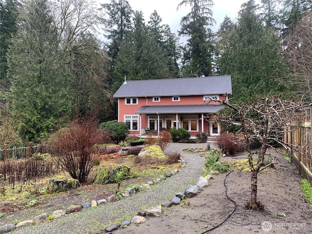 view of front facade with fence and a porch