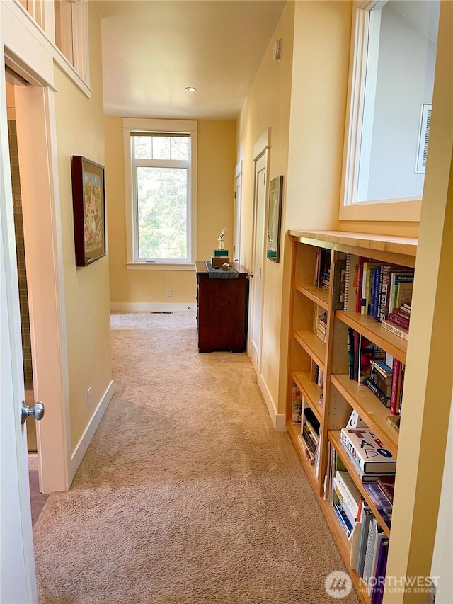 hallway with carpet and baseboards