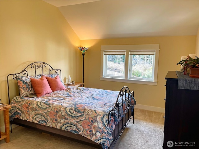 bedroom with carpet, vaulted ceiling, and baseboards